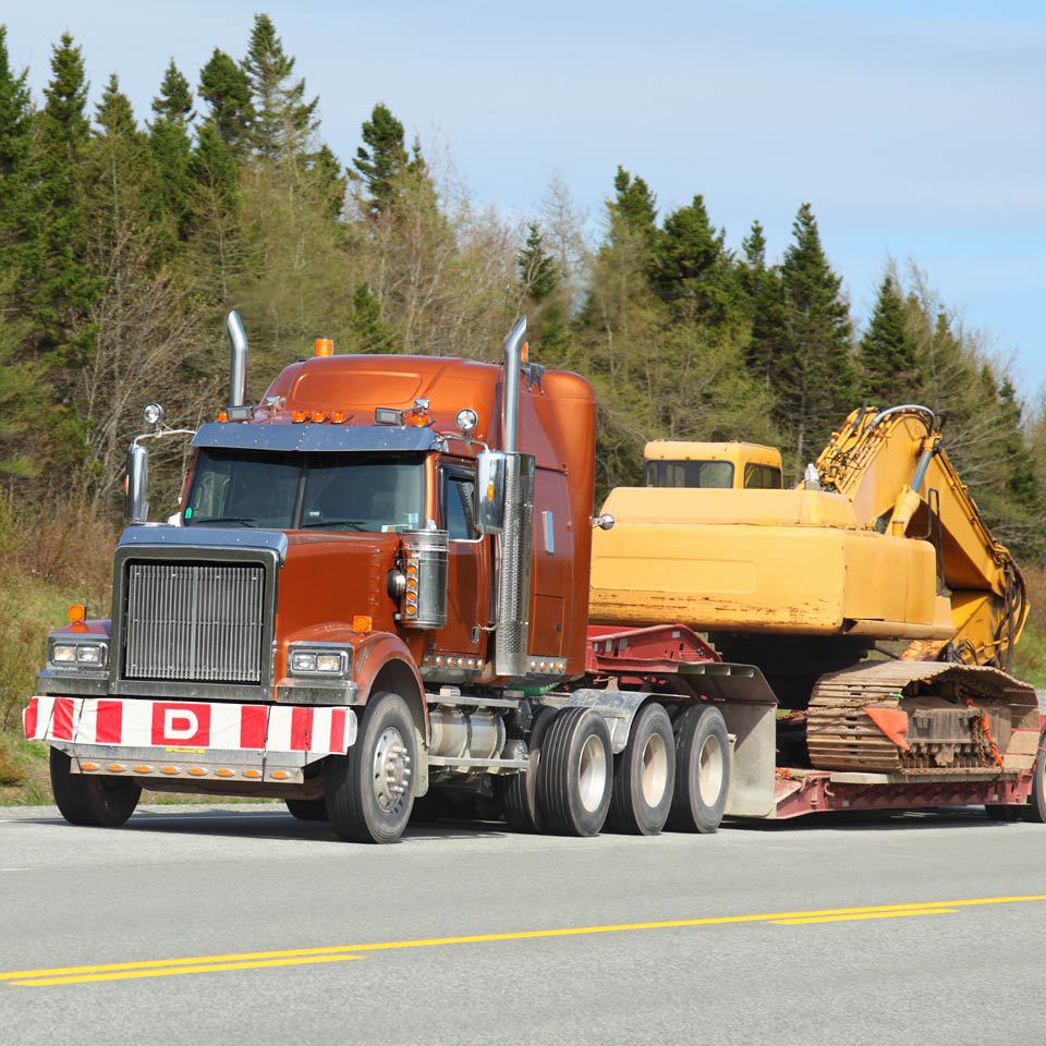red semi with yellow tractor